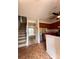 Kitchen area with stainless steel appliances, wood cabinets, and view to staircase at 7324 Pebblestone Dr # F, Charlotte, NC 28212