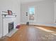 Simple bedroom with hardwood floors and a fireplace at 154 W End St, Chester, SC 29706