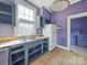 Kitchen with double sink, grey cabinets and white fridge at 154 W End St, Chester, SC 29706