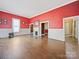 Living room with red walls, hardwood floors and fireplace at 154 W End St, Chester, SC 29706