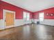 Living room with red walls and hardwood floors at 154 W End St, Chester, SC 29706