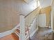 Wooden staircase with white railing and hardwood floors at 154 W End St, Chester, SC 29706
