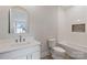 Bright bathroom features tile shower, white vanity with stone countertop and arched mirror at 407 Crepe Myrtle Ln, Weddington, NC 28104