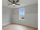 Bedroom featuring ceiling fan, hardwood floors, and window with neighborhood view at 407 Crepe Myrtle Ln, Weddington, NC 28104