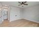 This bedroom features hardwood floors, decorative walls, and an ensuite bathroom at 407 Crepe Myrtle Ln, Weddington, NC 28104
