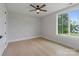 A bedroom featuring a decorative wall, hardwood floors, and a large window for natural light at 407 Crepe Myrtle Ln, Weddington, NC 28104