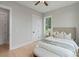 Cozy bedroom with neutral decor, hardwood floors, and a window with natural light at 407 Crepe Myrtle Ln, Weddington, NC 28104