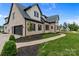 Charming brick home with a three-car garage, black shutters, and beautifully landscaped yard at 407 Crepe Myrtle Ln, Weddington, NC 28104