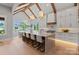 Bright, spacious kitchen with a large island, wooden beams, modern lighting, and stainless steel appliances at 407 Crepe Myrtle Ln, Weddington, NC 28104
