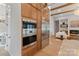 Modern kitchen with stainless steel appliances, wooden cabinets, and an open view to the living area at 407 Crepe Myrtle Ln, Weddington, NC 28104