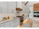 Modern kitchen with white cabinets, stainless steel appliances, and a stylish backsplash at 407 Crepe Myrtle Ln, Weddington, NC 28104