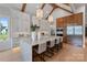 Bright kitchen features white cabinets, a marble island with seating, and stainless steel appliances at 407 Crepe Myrtle Ln, Weddington, NC 28104
