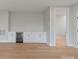Modern living space featuring hardwood floors, a built-in bar, and ample storage at 407 Crepe Myrtle Ln, Weddington, NC 28104