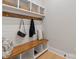 Mudroom featuring built-in bench with storage, hooks, and shelving at 407 Crepe Myrtle Ln, Weddington, NC 28104