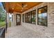 Covered outdoor patio featuring brick flooring, a ceiling fan, and views of the backyard at 407 Crepe Myrtle Ln, Weddington, NC 28104