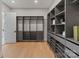 A modern walk-in closet features custom shelving, drawers, and ample storage space at 407 Crepe Myrtle Ln, Weddington, NC 28104