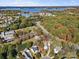 Stunning aerial view showcasing the neighborhood, mature trees, and beautiful lake at 8225 Ballymore Ct, Huntersville, NC 28078
