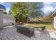 Covered stone patio featuring an outdoor seating area and manicured lawn at 8225 Ballymore Ct, Huntersville, NC 28078