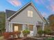 Charming home featuring light gray siding, a stylish front door, and white columns at 8225 Ballymore Ct, Huntersville, NC 28078