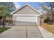 View of detached two car garage with white door and concrete driveway at 8225 Ballymore Ct, Huntersville, NC 28078