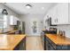Well-lit kitchen featuring butcher block countertops, stainless steel appliances, and white subway tile backsplash at 8225 Ballymore Ct, Huntersville, NC 28078