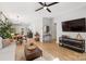 Open concept living room showcasing modern decor, an adjacent dining area, and wood floors at 8225 Ballymore Ct, Huntersville, NC 28078