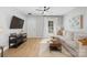 Cozy living room with a large TV, comfortable seating, and natural light at 8225 Ballymore Ct, Huntersville, NC 28078