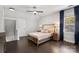 Bright main bedroom with hardwood floors, neutral walls, large window with drapes, and side tables with lamps at 8225 Ballymore Ct, Huntersville, NC 28078