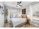 Primary bedroom features a ceiling fan, two windows, and hardwood floors at 8225 Ballymore Ct, Huntersville, NC 28078