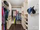 Walk-in closet with custom shelving, and hardwood floors at 8225 Ballymore Ct, Huntersville, NC 28078