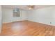 Bright bedroom with hardwood floors, large window, and ceiling fan at 1047 Mallard Dr, Rock Hill, SC 29732