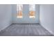 Spacious bedroom with gray carpeting and two large windows at 2212 Noble Townes Way, Charlotte, NC 28262