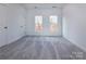 Bright bedroom featuring gray carpet and double closets at 2212 Noble Townes Way, Charlotte, NC 28262