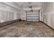Unfinished garage with overhead door and concrete floor at 2212 Noble Townes Way, Charlotte, NC 28262
