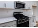 Stainless steel appliances and white quartz countertops at 2212 Noble Townes Way, Charlotte, NC 28262