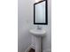 Modern powder room with pedestal sink and framed mirror at 2212 Noble Townes Way, Charlotte, NC 28262