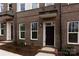 Dark brown brick townhouse with black front door at 2212 Noble Townes Way, Charlotte, NC 28262