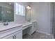 Double vanity bathroom with grey tile flooring at 2220 Noble Townes Way, Charlotte, NC 28262