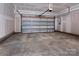 Spacious garage with open overhead door and concrete floor at 2220 Noble Townes Way, Charlotte, NC 28262