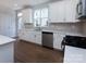 Modern kitchen with white cabinets, quartz countertops and stainless steel appliances at 2220 Noble Townes Way, Charlotte, NC 28262