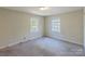 Bright bedroom with two windows and carpet at 3316 Valley Grove Rd, Charlotte, NC 28227