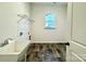 Bright laundry room, includes a utility sink, shelving and tile flooring at 419 Lucky Nw Dr # 22, Concord, NC 28027