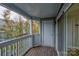 A spacious wooden balcony overlooking the neighborhood foliage and other surrounding buildings at 525 N Graham St # 3A, Charlotte, NC 28202