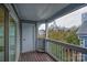 A spacious wooden balcony overlooking the city skyline and neighborhood foliage at 525 N Graham St # 3A, Charlotte, NC 28202