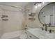 Well lit bathroom features a shower/tub combo, modern vanity, and decorative wall shelves at 525 N Graham St # 3A, Charlotte, NC 28202