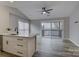 Bright open kitchen with a ceiling fan, sleek countertops, and sliding glass doors to the balcony at 525 N Graham St # 3A, Charlotte, NC 28202