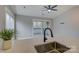 Bright kitchen with sleek countertops, stainless sink, and sliding glass doors to the balcony at 525 N Graham St # 3A, Charlotte, NC 28202