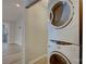Convenient laundry room features modern stacked washer and dryer and wood floors at 525 N Graham St # 3A, Charlotte, NC 28202