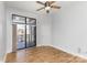 Bedroom with hardwood floors, balcony access, and ceiling fan at 909 E 7Th St # 241, Charlotte, NC 28204