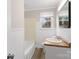 Bright bathroom with a white vanity, tub, and window providing natural light at 27 Sw Barbee Rd, Concord, NC 28027